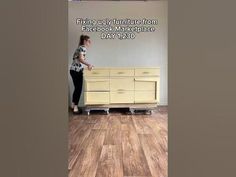 a woman standing next to a yellow dresser