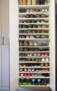 the closet is filled with many pairs of shoes