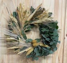 a wreath is hanging on a wooden wall