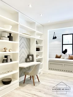 a white room with shelves, chairs and a desk in front of a large window