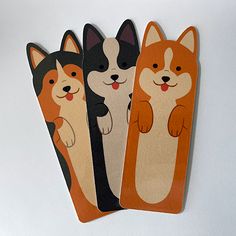 three bookmarks with dogs on them sitting next to each other in front of a white background