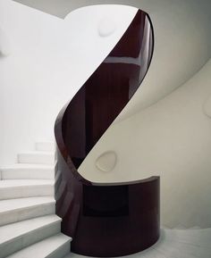 a white and brown spiral staircase in a building