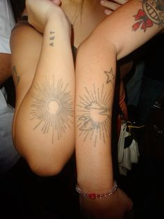 two people with tattoos on their arms