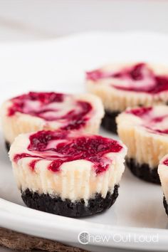 mini cheesecakes with raspberry filling on a white plate