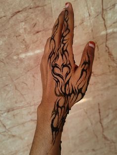 a person's hand with a tattoo on it