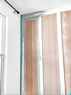 an unfinished room with wood paneling and paint on the walls