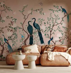 a living room with two couches and birds on the wall next to each other