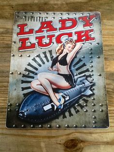 a lady luck sign on the side of a wooden fence