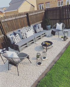 an outdoor seating area with gravel and wood