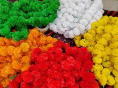 many different colored flowers are on the table and ready to be used as decorations or decoration