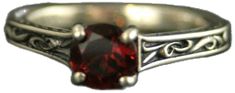 a close up of a ring with a red stone