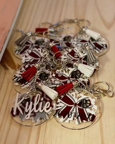 a bunch of key chains sitting on top of a wooden table