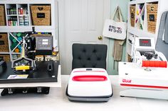 two sewing machines sitting on top of a white counter next to each other in a room