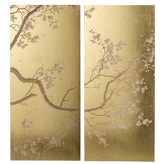 two gold wall panels with white flowers and branches painted on the sides, each panel in different colors