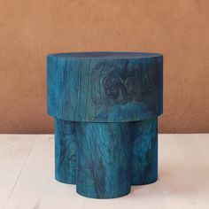 two wooden stools sitting on top of a white table