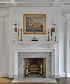 a fireplace with a painting on the wall above it