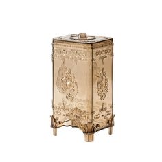 an ornately decorated gold metal box on stand with two legs and one door open