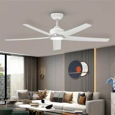 a white ceiling fan in a living room with modern furniture and decor on the walls