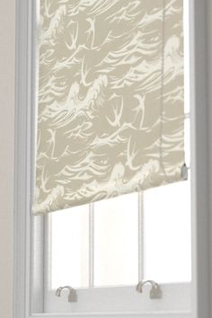 an open window with roman shades on it