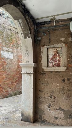 an old brick building with graffiti on the walls and a window in the wall that has been torn open