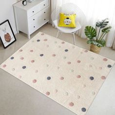 a white rug with polka dots on it in a room next to a chair and potted plant