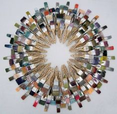 a circle made out of wooden sticks with different colors and sizes in the shape of a sunburst