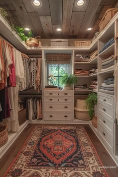 a walk in closet with lots of drawers and rugs on the floor next to it