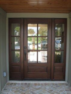 the front door to a home with two glass doors