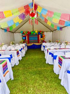 the inside of a tent with tables and chairs set up for a party or celebration