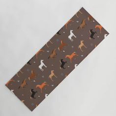 a tie with dogs on it sitting on top of a white table next to a gray wall