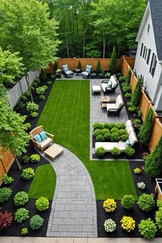 an outdoor patio with seating and landscaping in the back yard, surrounded by green grass