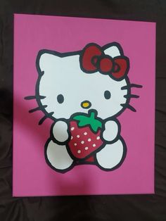 a hello kitty holding a strawberry on a pink background