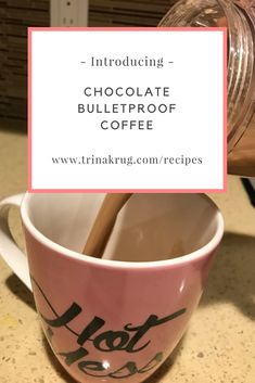 a pink coffee cup with a spoon in it and the words, chocolate bulletproof coffee