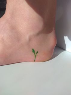 Leaf growing from heel tattoo idea I Am Rooted But I Flow Tattoo, Water Plant Tattoo, Interesting Tattoo Placement, Green Thumb Tattoo, Small Atla Tattoo, Plant Based Tattoo, Growing Tattoo Ideas, Small Leaf Tattoo, Small Plant Tattoo