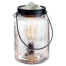 a glass jar with a candle inside on a white background