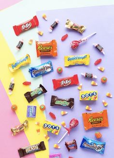 an assortment of candy on a rainbow colored background