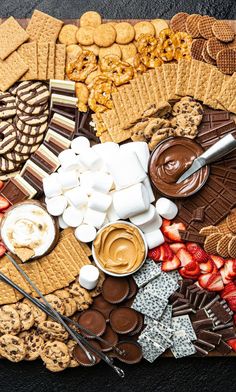 a platter filled with cookies, marshmallows and chocolate