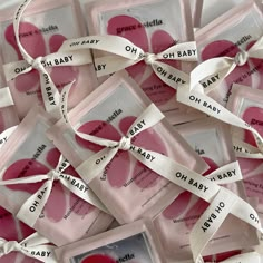 baby shower soaps are wrapped in white ribbon and tied around pink heart shaped tags