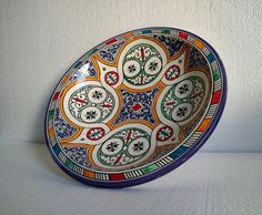 a colorful bowl sitting on top of a white table