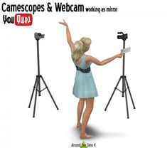 a woman standing next to a tripod with her hand up and pointing at something