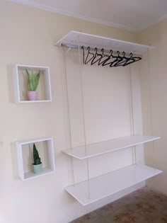 some white shelves are hanging on the wall