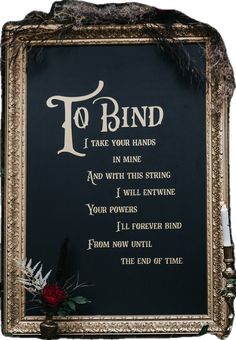 a black plaque with the words to bind and flowers on it's front side