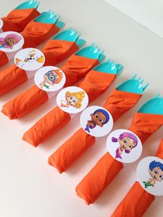 there are many orange toothbrushes with cartoon characters on the top one is blue