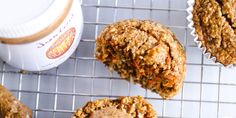 muffins cooling on a wire rack next to a container of yogurt