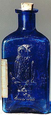 a blue glass bottle with an eagle on it