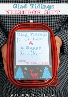 a person holding a christmas gift in their hand with the text glad tiings neighbor gift