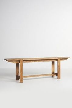 a wooden table sitting on top of a white floor