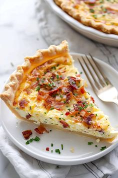 a slice of bacon quiche on a plate with a fork and knife next to it