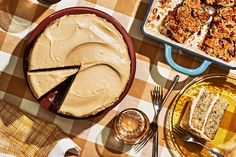 a table topped with pies and desserts on top of a checkered table cloth