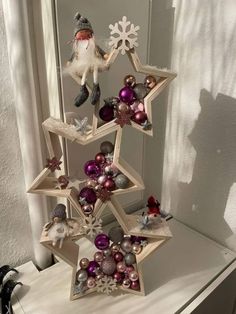 a christmas tree made out of wooden stars and ornaments